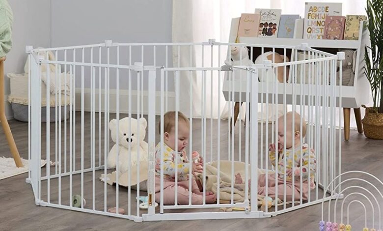 White wooden baby gate installed across hallway doorway with easy-open latch mechanism