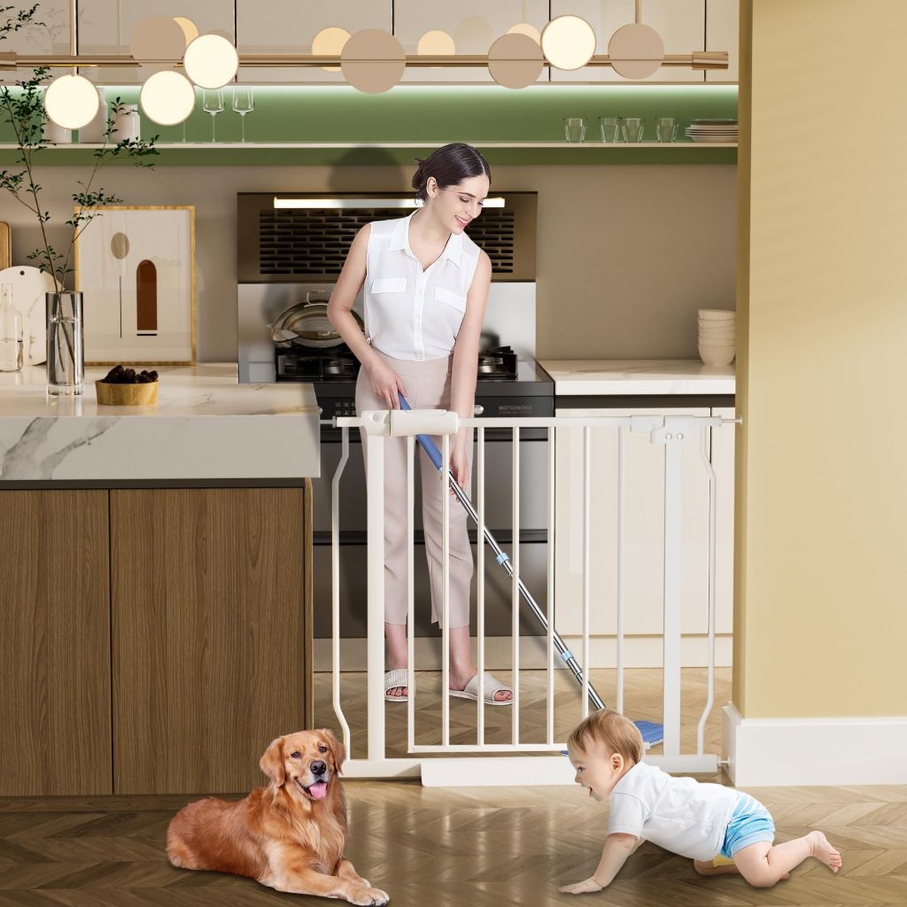 Pressure-mounted metal baby gate blocking kitchen entrance with child playing safely behind barrier