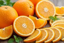 Fresh whole oranges and orange slices showing vitamin C-rich flesh that provides antioxidant protection against oxidative stress