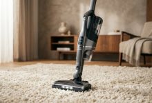 Dyson vacuum standing on plush cream shag carpet with title overlay.