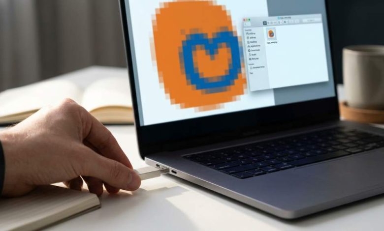 Designer fixing pixelated logo artwork in Illustrator