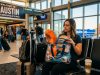 Traveler comparing affordable neck pillows at an airport terminal.