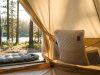 Memory foam camping pillow resting inside a tent near a sleeping bag.